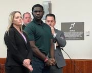 Geremiah Burrell, 18, stands with his attorneys Heather Vincent and Graeme Spicer at his sentencing on Thursday, Feb. 8, 2024.