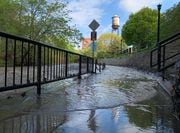 A portion of the Onondaga Creekwalk is flooded near the Mission Landing condos at Franklin Square May 15, 2019. 