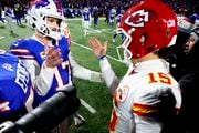 Buffalo Bills quarterback Josh Allen (17) greets Kansas City Chiefs quarterback Patrick Mahomes (15) after playing in an NFL AFC division playoff football game, Sunday, Jan. 21, 2024, in Orchard Park, N.Y. (AP Photo/Jeffrey T. Barnes)