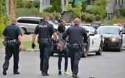 A woman is handcuffed and led to a police car following a fight and stabbing Wednesday in the 100 block of Herbst Avenue in Syracuse. SYR