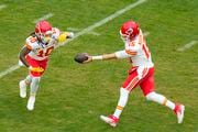 Kansas City Chiefs quarterback Patrick Mahomes (15) hands the ball off to Kansas running back Isiah Pacheco (10) during the AFC Championship NFL football game between the Baltimore Ravens and the Kansas City Chiefs, Sunday, Jan. 28, 2024, in Baltimore. The Chiefs won 17-10.