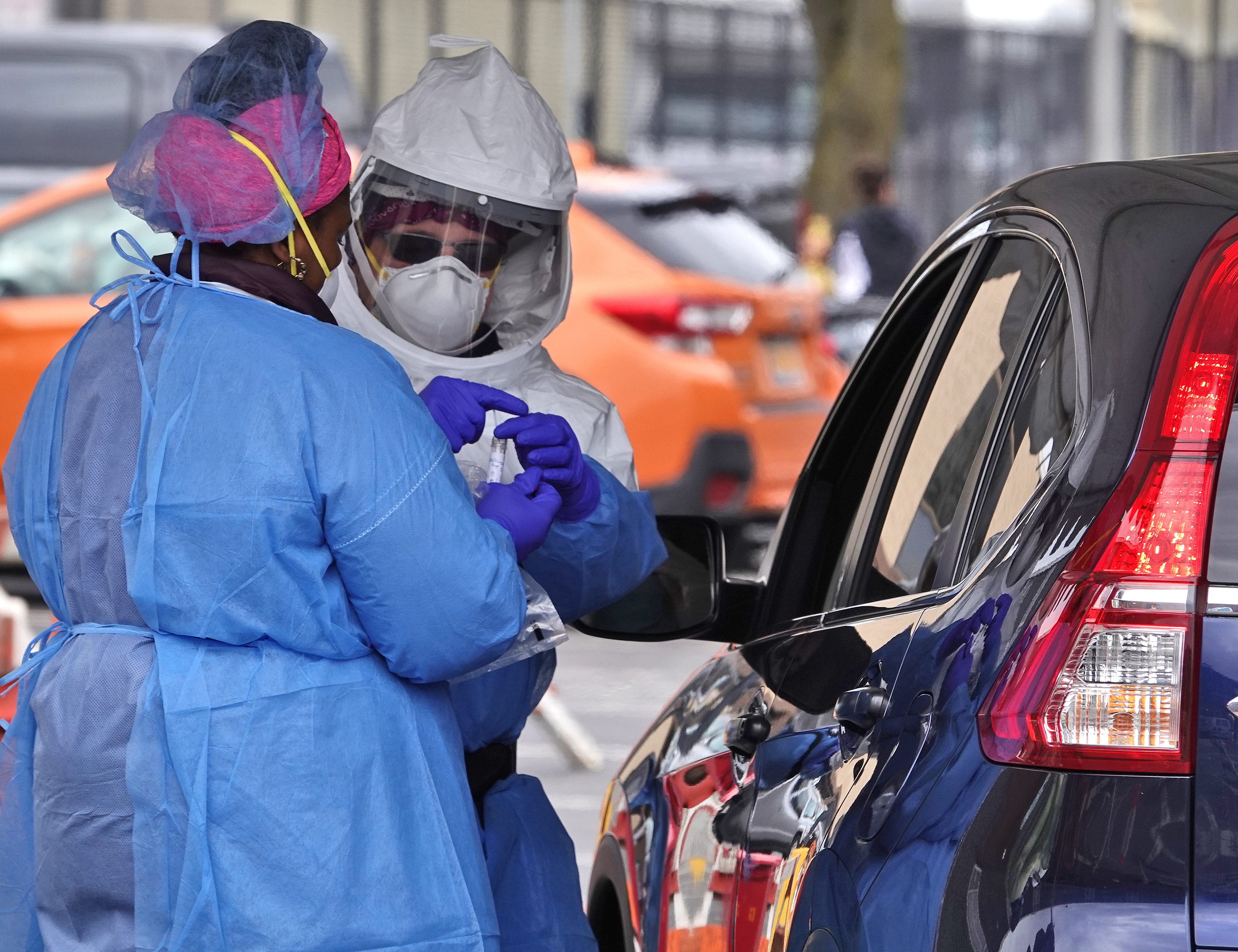 Workers secure a sample taken from a motorist