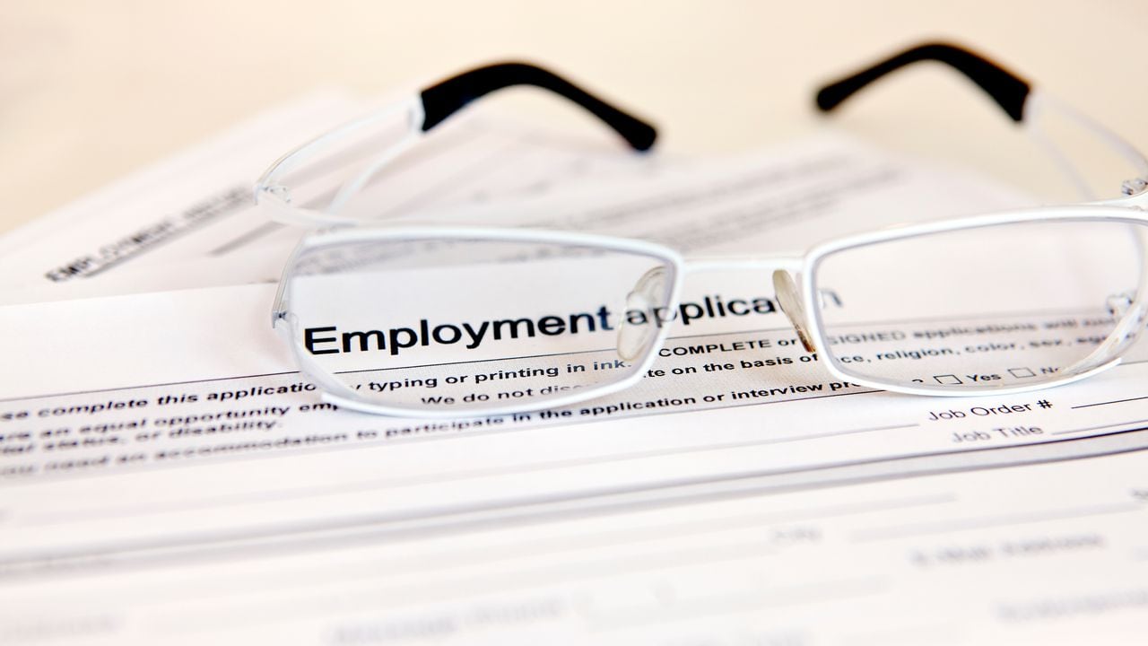Eyeglasses rest on top of an employment application