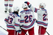 New York Rangers left wing Jimmy Vesey (26) celebrates after his empty-net goal with center Mika Zibanejad (93) and defenseman Adam Fox (23) during the third period of an NHL hockey game against the Anaheim Ducks, Sunday, Jan. 21, 2024, in Anaheim, Calif. (AP Photo | Kyusung Gong)